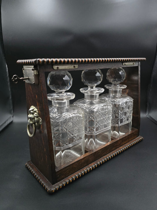 Antique Triple Decanter Tantalus Set with Lock & Key – Cut Crystal & Wooden Frame with Brass Lion Fittings – Excellent Condition